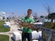 This happy young guy holds out a trophy walleye caught on Lake Erie.