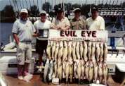 Five men pose with a great bounty of fish.