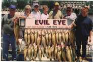 Group of seven fishermen and their catch of the day.